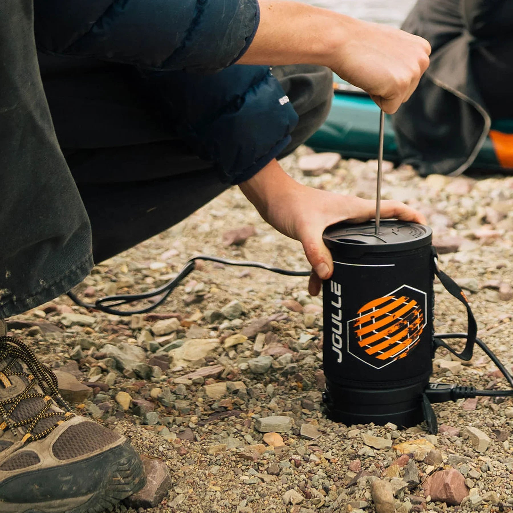 Stoke Voltaics portable kettle pot in use outdoors on rocky ground
